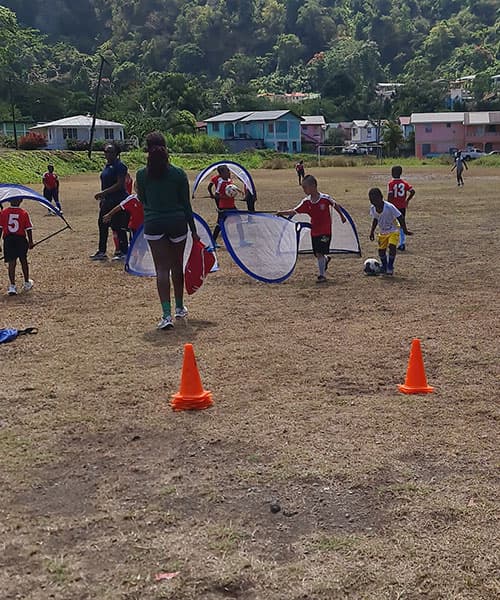 Coaches and players setting up goals for a practice match