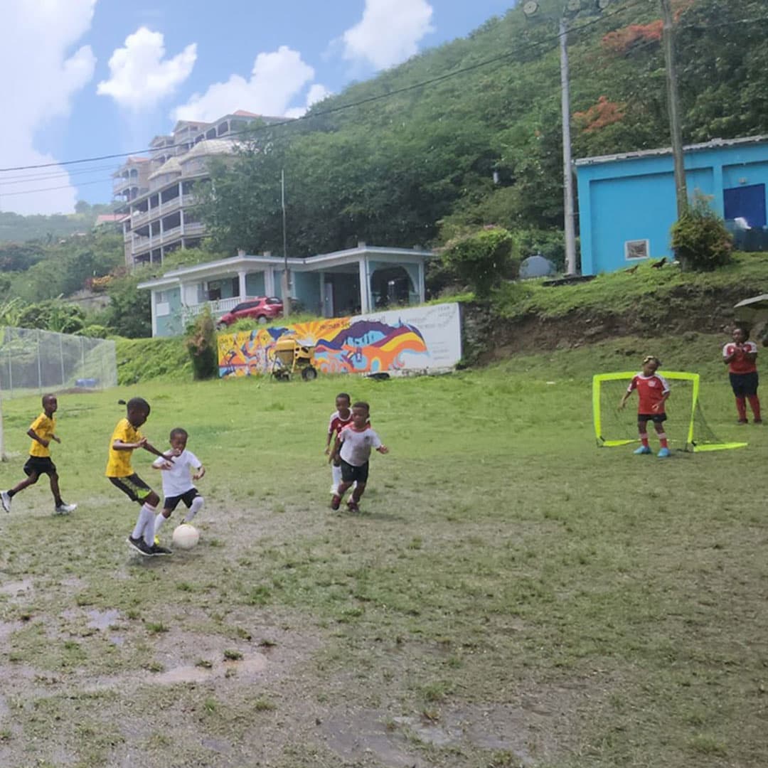 Children putting on bibs to play a practice match
